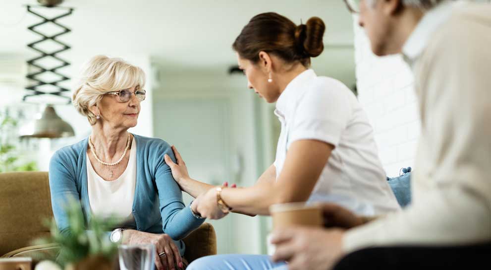 A caregiver bonding with an elderly person through an engaging activity or conversation.